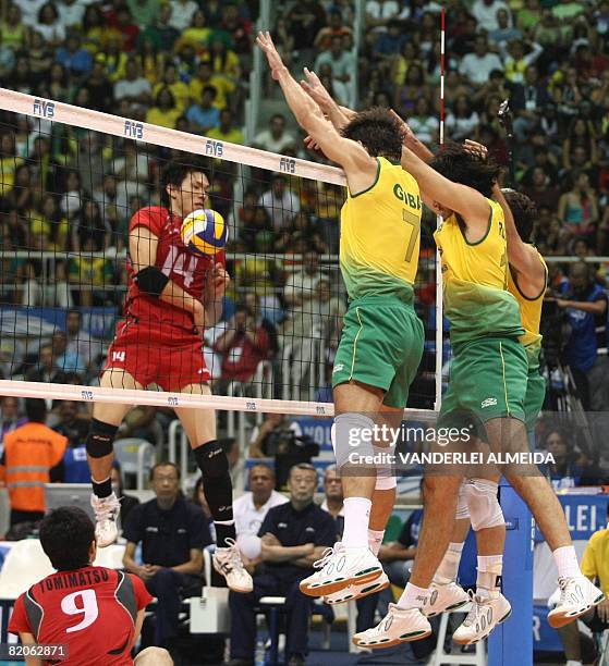 Brazil's Gilberto Gody , Dante Amaral and Marcelinho block the ball from Japan's Tatsuya Fukuzawa during their International Volleyball Federation...