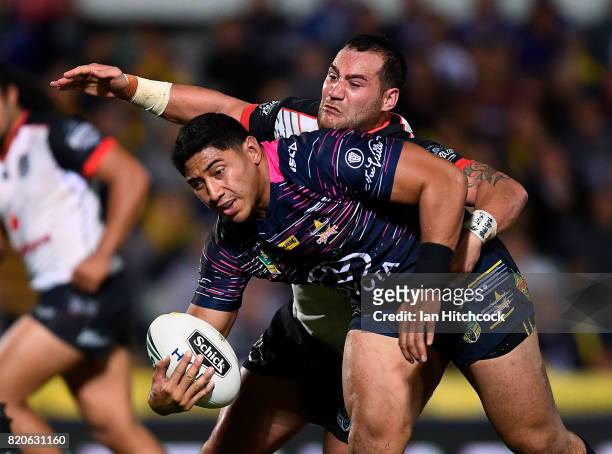 Jason Taumalolo of the Cowboys is tackled by Bodene Thompson of the Warriors during the round 20 NRL match between the North Queensland Cowboys and...