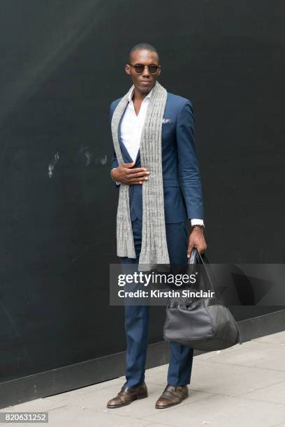 Business Coach Joell Anderson wears Harry Brown suit, Jack and Jones sunglasses, David Preston shoes and an Armani bag on day 3 of London...