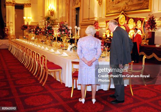 Queen Elizabeth II, accompanied by Sir Hugh Roberts, the Director of the Royal Collection, views the Summer Opening exhibition at Buckingham Palace...