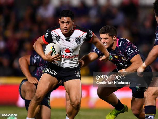 Roger Tuivasa-Sheck of the Warriors gets past Corey Jensen of the Cowboys during the round 20 NRL match between the North Queensland Cowboys and the...