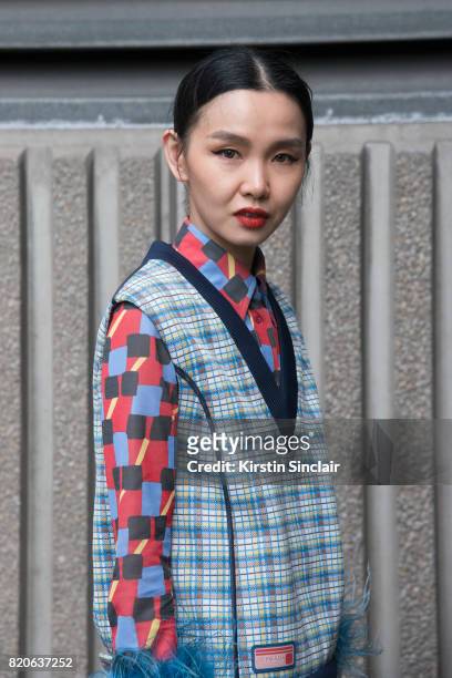 Fashion buyer Sherry Shen wears a Prada jumper and shirt on day 1 of London Collections: Men on June 9, 2017 in Paris, France.