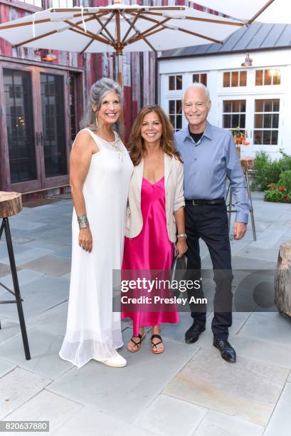 Joan Hornig, Karen Meel and Dennis Meel attend Hamptons Event to Celebrate FIT at The Hornig Residence on July 21, 2017 in Water Mill, New York.