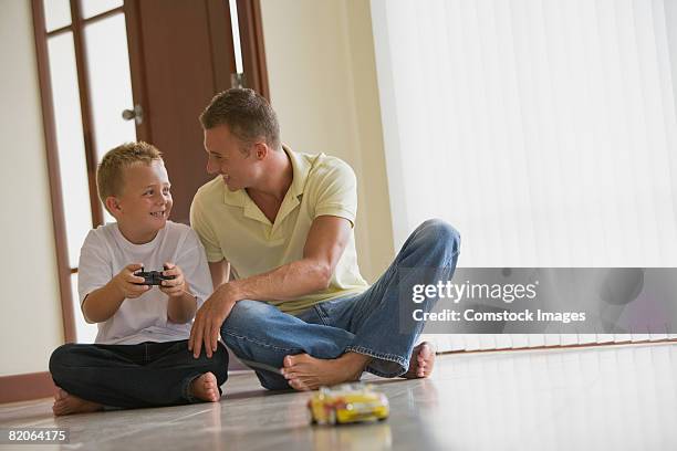 father and son playing with toy car - car remote toy stock pictures, royalty-free photos & images