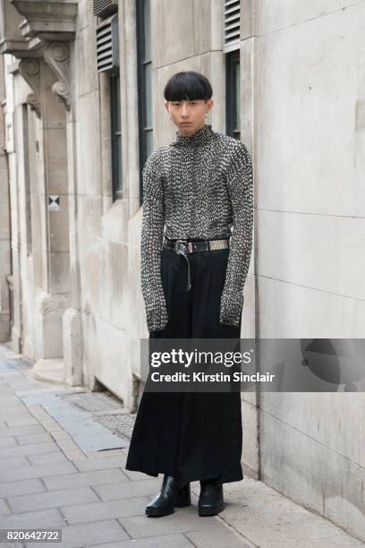 Model Xander Ang wears an Issey Miyake top, Commes des Garcons trousers, Balenciaga shoes and a vintage belt on day 1 of London Collections: Men on...