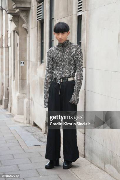 Model Xander Ang wears an Issey Miyake top, Commes des Garcons trousers, Balenciaga shoes and a vintage belt on day 1 of London Collections: Men on...