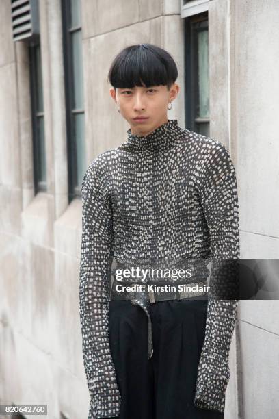 Model Xander Ang wears an Issey Miyake top, Commes des Garcons trousers and a vintage belt on day 1 of London Collections: Men on June 9, 2017 in...