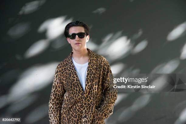 Zac Battle wears a Wackomania coat, Ray Ban sunglasses on day 1 of London Collections: Men on June 9, 2017 in Paris, France.