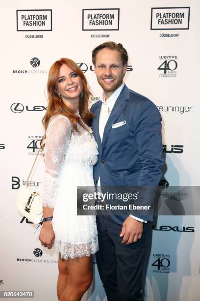 Irina Schmidt and Thomas Hoehn attend the Breuninger show during Platform Fashion July 2017 at Areal Boehler on July 21, 2017 in Duesseldorf, Germany.