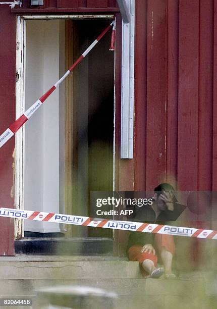 Woman cries outside a building after clashes with asylum seekers at Valer 45 kilometres, southeast of Oslo on July 25, 2008. More than 20 people...