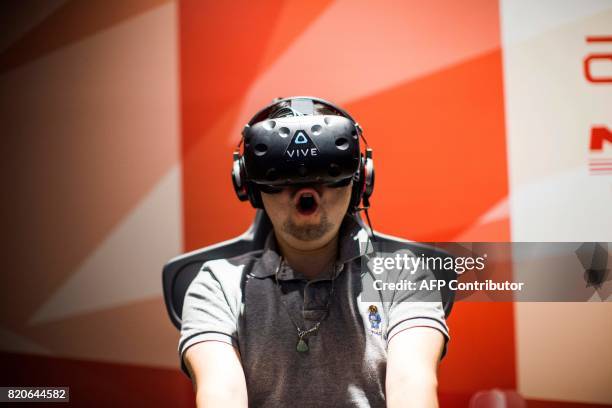 Man plays a virtual reality Mario Kart game at the Bandai Namco game facility of VR Zone Shinjuku in Tokyo on July 22, 2017. / AFP PHOTO / Behrouz...