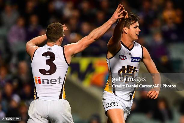 Tom Mitchell and Daniel Howe of the Hawks celebrates a goal during the 2017 AFL round 18 match between the Fremantle Dockers and the Hawthorn Hawks...