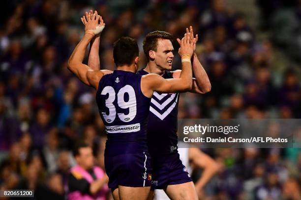 Josh Deluca and Ryan Nyhuis of the Dockers celebrates a goal during the 2017 AFL round 18 match between the Fremantle Dockers and the Hawthorn Hawks...