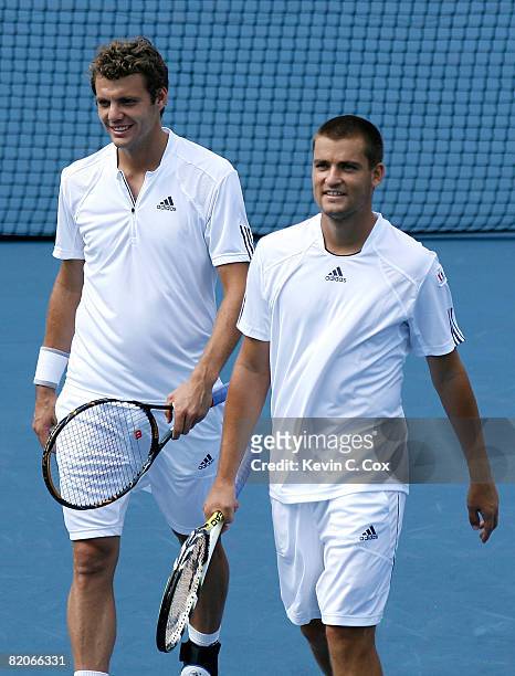 Paul-Henri Mathieu of France and Mikhail Youzhny of Russia confer between points against Daniel Nestor and Nenad Zimonjic of Serbia during the Rogers...