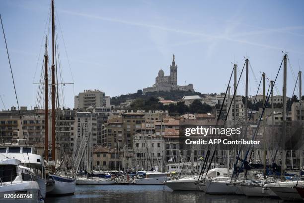 The Notre-Dame de la Garde basilica is pictured from the Vieux Port on July 22 prior to a 22,5 km individual time-trial, the twentieth stage of the...