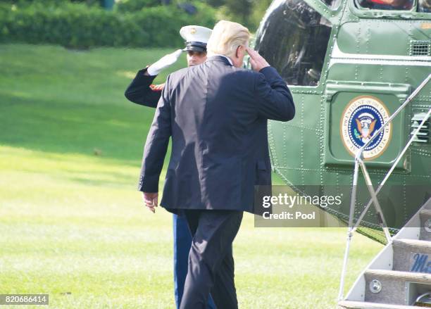 President Donald Trump salutes the Marine Guard as he departs the White House to participate in the commissioning ceremony for the USS Gerald R. Ford...