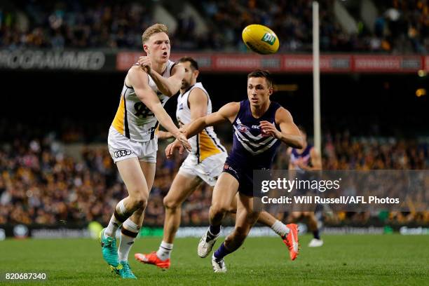 James Sicily of the Hawks handpasses the ball during the round 18 AFL match between the Fremantle Dockers and the Hawthorn Hawks at Domain Stadium on...