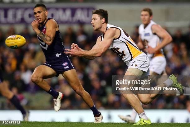 Liam Shiels of the Hawks handpasses the ball during the round 18 AFL match between the Fremantle Dockers and the Hawthorn Hawks at Domain Stadium on...