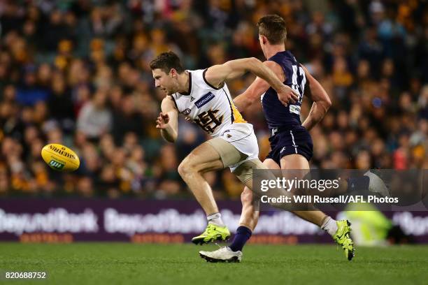 Liam Shiels of the Hawks and Ryan Nyhuis of the Dockers chase the ball during the round 18 AFL match between the Fremantle Dockers and the Hawthorn...