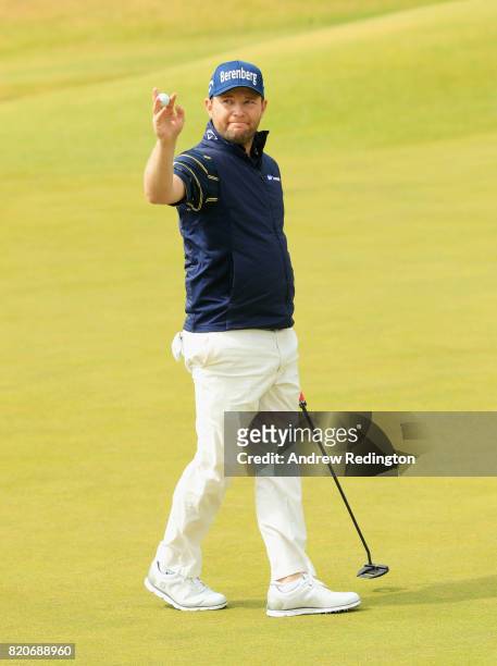 Branden Grace of South Africa acknowledges the crowd on the 18th green after shooting a 62, the lowest round in major history during the third round...
