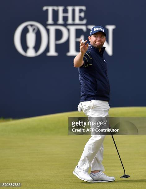 South Africa's Branden Grace reacts after holing out on the 18th green after his third round 62 on day three of the Open Golf Championship at Royal...