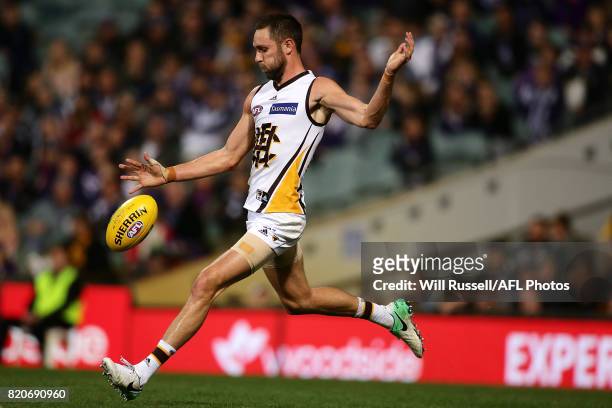 Jack Gunston of the Hawks kicks the ball during the round 18 AFL match between the Fremantle Dockers and the Hawthorn Hawks at Domain Stadium on July...