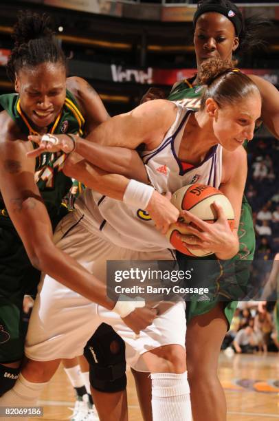 Diana Taurasi of the Phoenix Mercury grabs a rebound against Yolanda Griffith of the Seattle Storm on July 25 at U.S. Airways Center in Phoenix,...