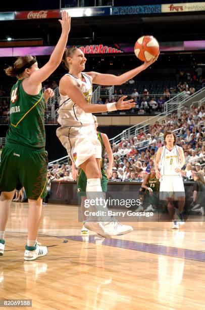 Diana Taurasi of the Phoenix Mercury shoots against Katie Gearlds of the Seattle Storm on July 25 at U.S. Airways Center in Phoenix, Arizona. NOTE TO...