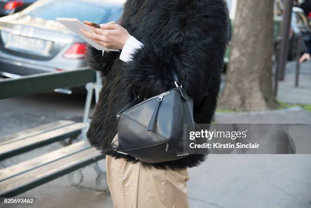 Guest wears a Loewe bag on day 3 during Paris Fashion Week Autumn/Winter 2017/18 on March 2, 2017 in Paris, France.