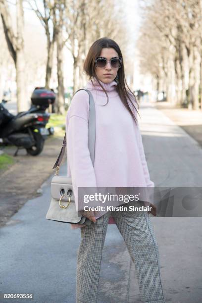 Editor in chief of l"u2019OFFICIEL Ukraine, Ulyana Boyko wears a JW Anderson bag, Céline sweater, Sandro trousers on day 3 during Paris Fashion Week...