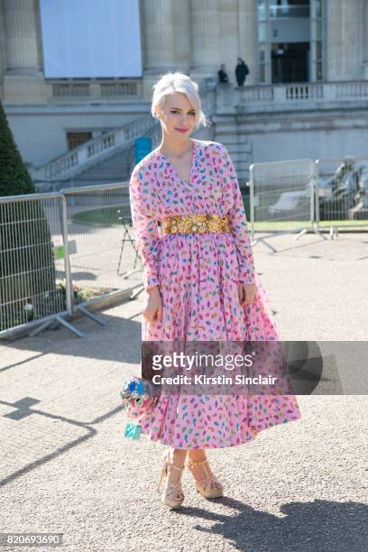 Singer Aria Crescendo wears a Manish Arora dress and bag and Yves Saint Laurent shoes on day 3 during Paris Fashion Week Autumn/Winter 2017/18 on...