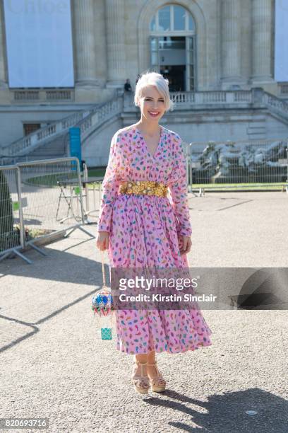 Singer Aria Crescendo wears a Manish Arora dress and bag and Yves Saint Laurent shoes on day 3 during Paris Fashion Week Autumn/Winter 2017/18 on...
