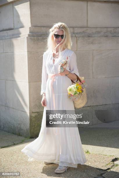 Fashion and accessories designer for Little Miss Ella Sarah Gray wears a vintage dress, Little Miss Ella bag and converse trainers on day 3 during...