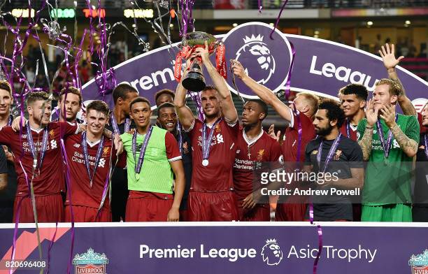 Jordan Henderson of Liverpool lifts the Premier League Asia Trophy after winning the Premier League Asia Trophy match between Liverpool FC and...
