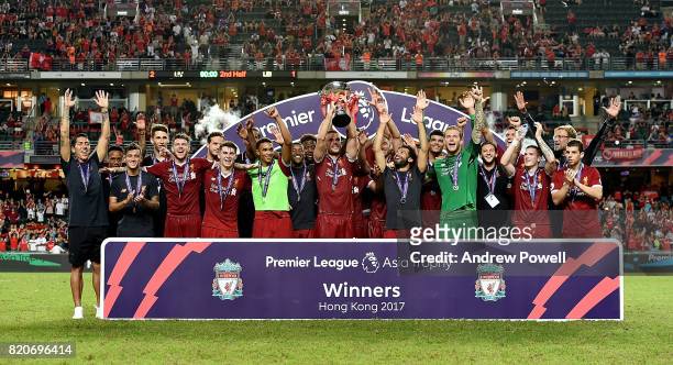 Jordan Henderson of Liverpool lifts the Premier League Asia Trophy after winning the Premier League Asia Trophy match between Liverpool FC and...