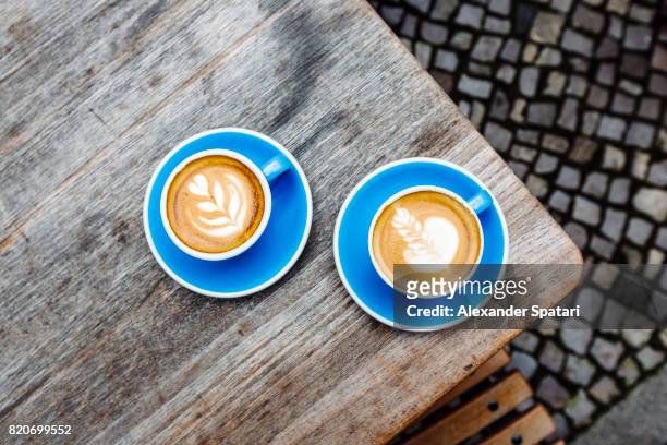 two blue cups of coffee on the table, high angle view - coffee above stock-fotos und bilder