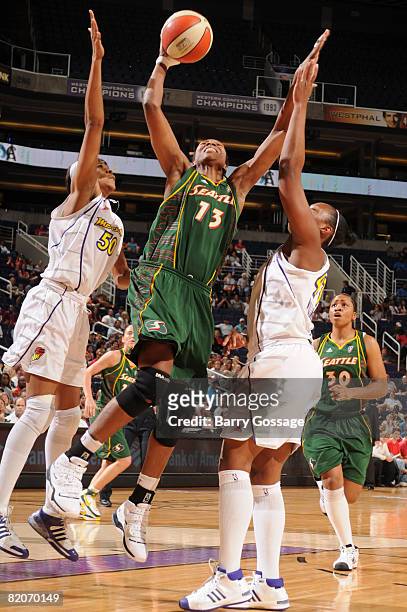 Yolanda Griffith of the Seattle Storm shoots against Le'coe Willingham of the Phoenix Mercury on July 25 at U.S. Airways Center in Phoenix, Arizona....