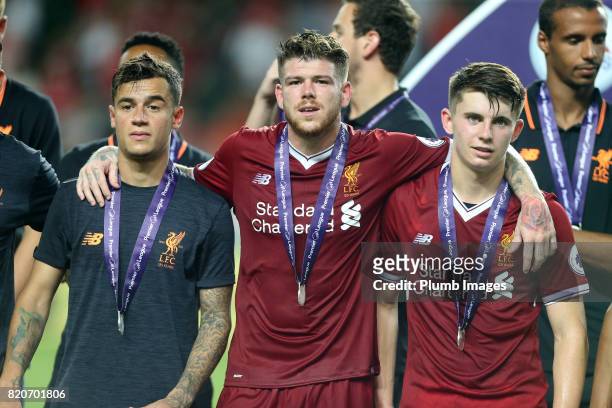 Philippe Coutinho, Alberto Moreno and John Flanagan of Liverpool with their Premier League Asia Trophy medals after the Premier League Asia Trophy...
