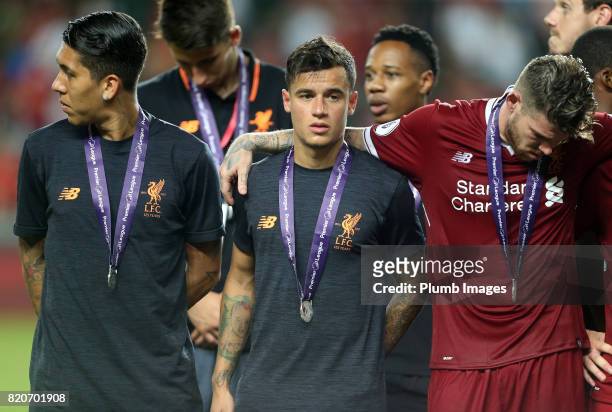 Philippe Coutinho, Alberto Moreno and Roberto Firmino of Liverpool with their Premier League Asia Trophy medals after the Premier League Asia Trophy...