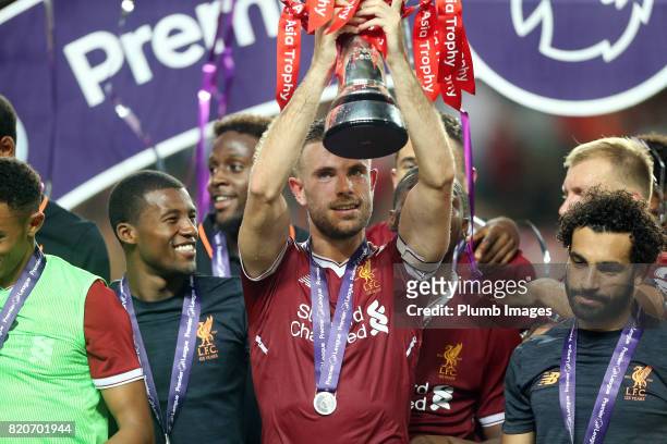Jordan Henderson of Liverpool lifts the Premier League Asia Trophy after the Premier League Asia Trophy Final between Liverpool FC and Leicester City...