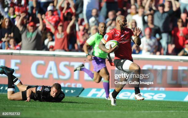 Lionel Mapoe of Lions scoring his try with Curwin Bosch of the Sharks on the ground during the Super Rugby Quarter final between Emirates Lions and...