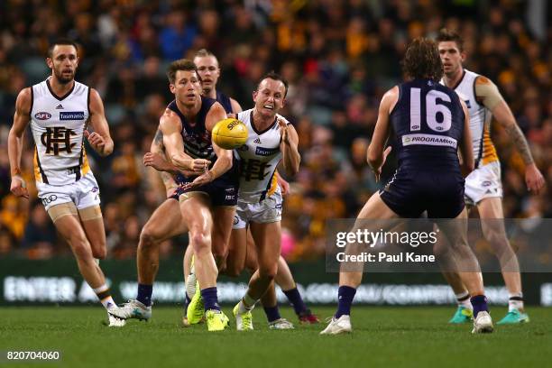 Lee Spurr of the Dockers handballs during the round 18 AFL match between the Fremantle Dockers and the Hawthorn Hawks at Domain Stadium on July 22,...