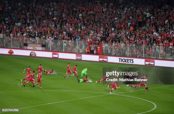 The players of the Union Berlin slide over the pitch during the game between Union Berlin and the Queens Park Rangers on july 22, 2017 in Berlin,...