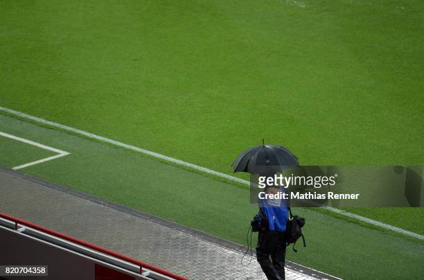 Photographer with a umbrella during the game between Union Berlin and the Queens Park Rangers on july 22, 2017 in Berlin, Germany.