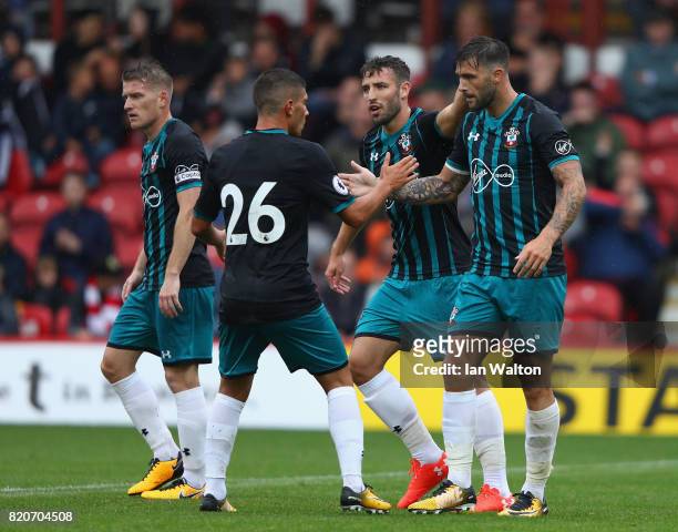 Charlie Austin of Southampton celebrates scoring a goal during the Pre Season Friendly match between Brentford and Southampton at Griffin Park on...