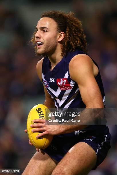 Griffin Logue of the Dockers looks to pass the ball during the round 18 AFL match between the Fremantle Dockers and the Hawthorn Hawks at Domain...