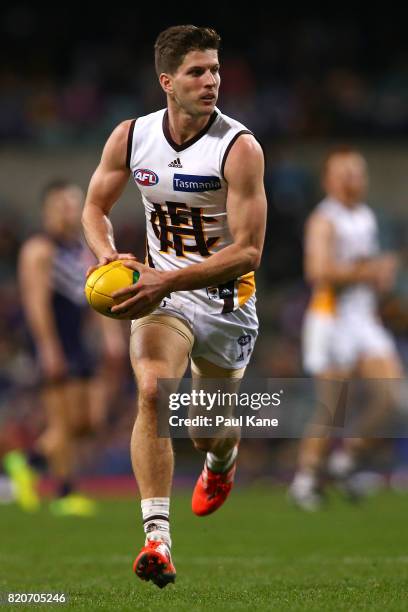 Luke Breust of the Hawks looks to pass the ball during the round 18 AFL match between the Fremantle Dockers and the Hawthorn Hawks at Domain Stadium...