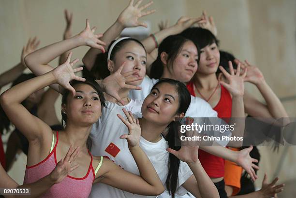 Members of a cheering squad pose during training training on July 25, 2008 in Yanjiao of Hebei Province, China. A total of 27 cheering squads which...