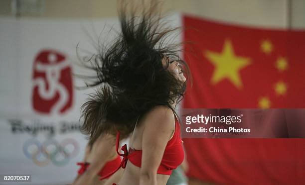 Members of a cheering squad dance during training training on July 25, 2008 in Yanjiao of Hebei Province, China. A total of 27 cheering squads which...