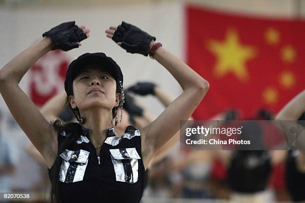 Members of a cheering squad dance during training training on July 25, 2008 in Yanjiao of Hebei Province, China. A total of 27 cheering squads which...